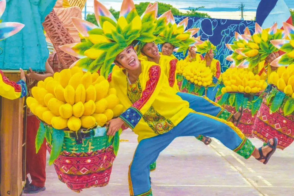 Dancers carrying baskets of mangoes at the Manggahan Festival